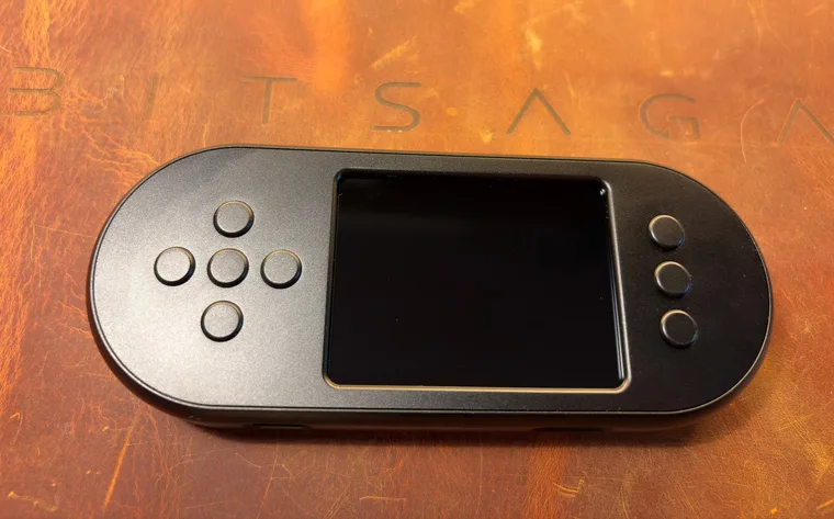 The black SeedSigner+ Premium seen face on, its brushed grey front plate carrying the dark 2.8 inch screen, the direction pad on the left and three buttons on the right
