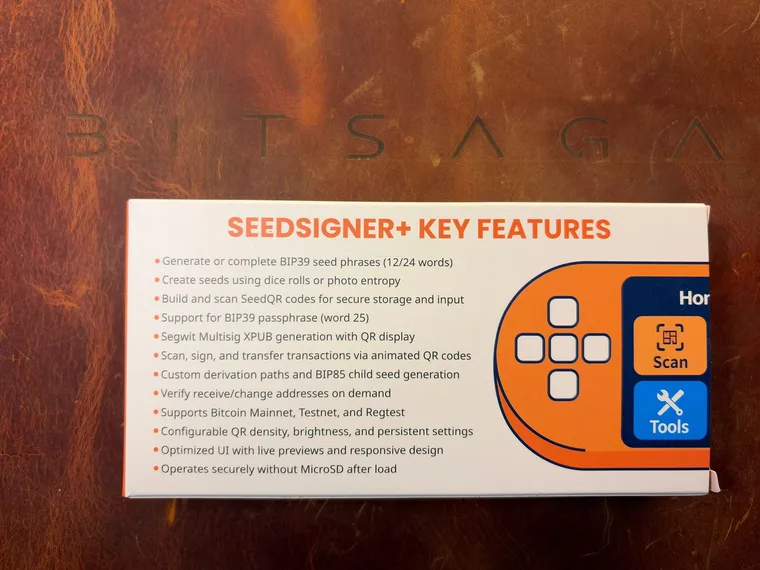 The retail box, printed with SEEDSIGNER+ KEY FEATURES and a list of what the device does, next to the orange and blue Home, Scan and Tools icons from its menu